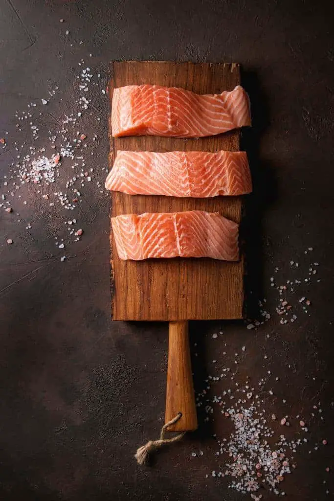 salmon fillets on wood plank
