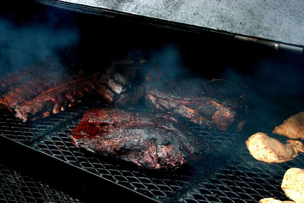 smoked meats on barbecue grill